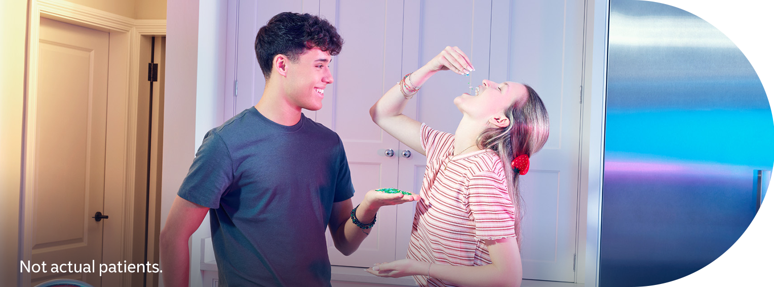 Two young adults in a kitchen. Not actual patients. Vaccination disclaimer included.